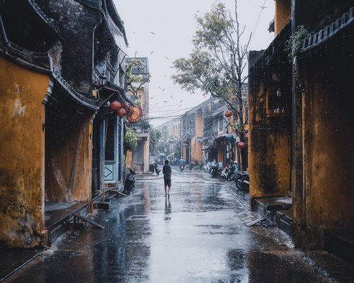 person walking on a quiet urban street